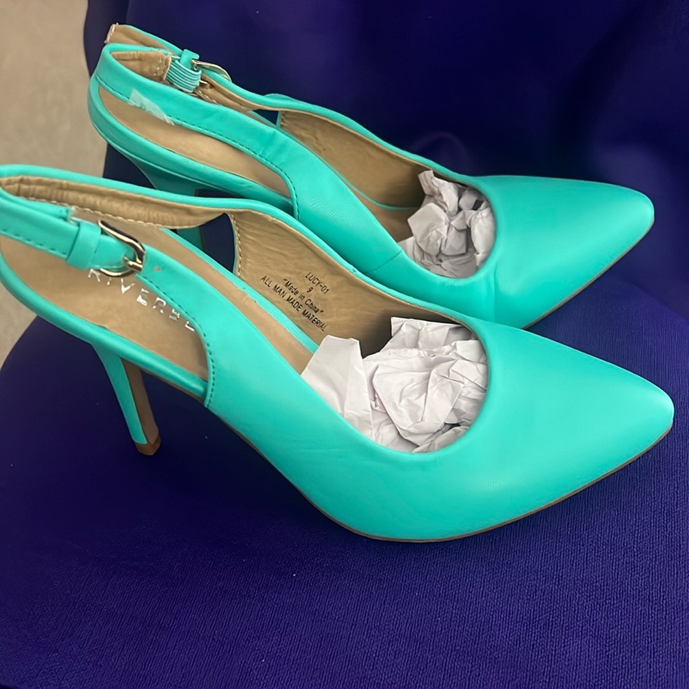 A pair of 2 1/2 inch heels, closed toe shoes, back straps never worn beautiful